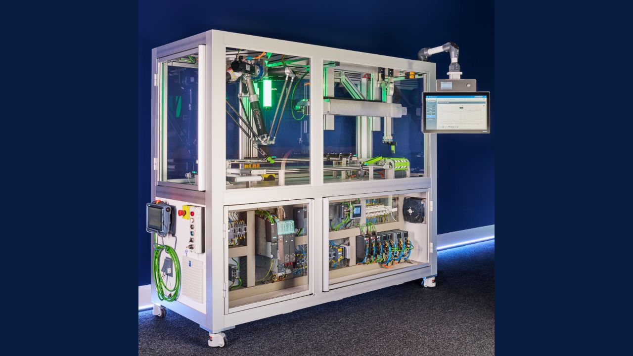 Automated industrial machine with robotic arm, conveyor system, control panel, and internal wiring in white frame on blue ba