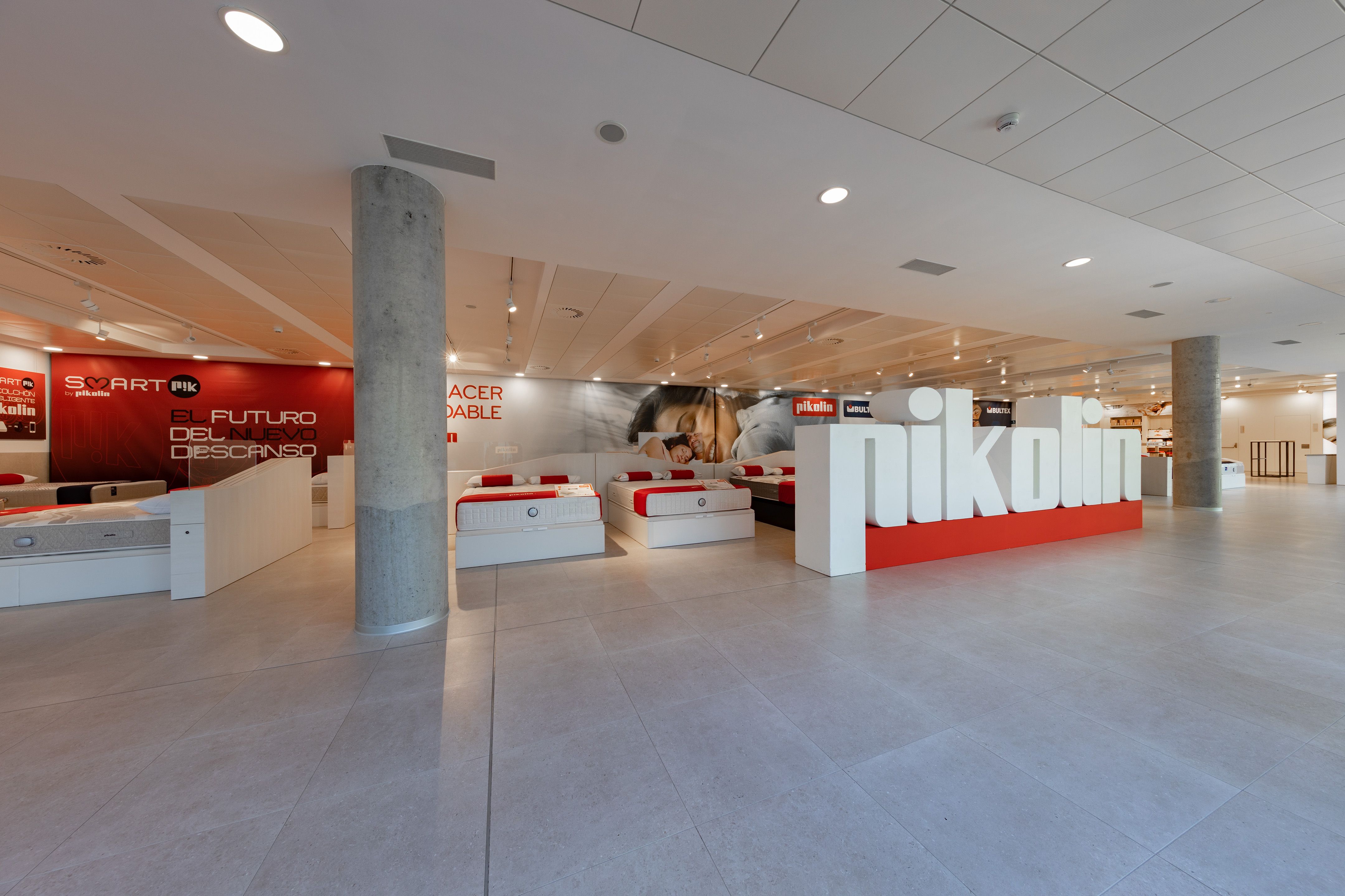 A showroom with Pikolin mattresses. The company name is displayed in large letters.