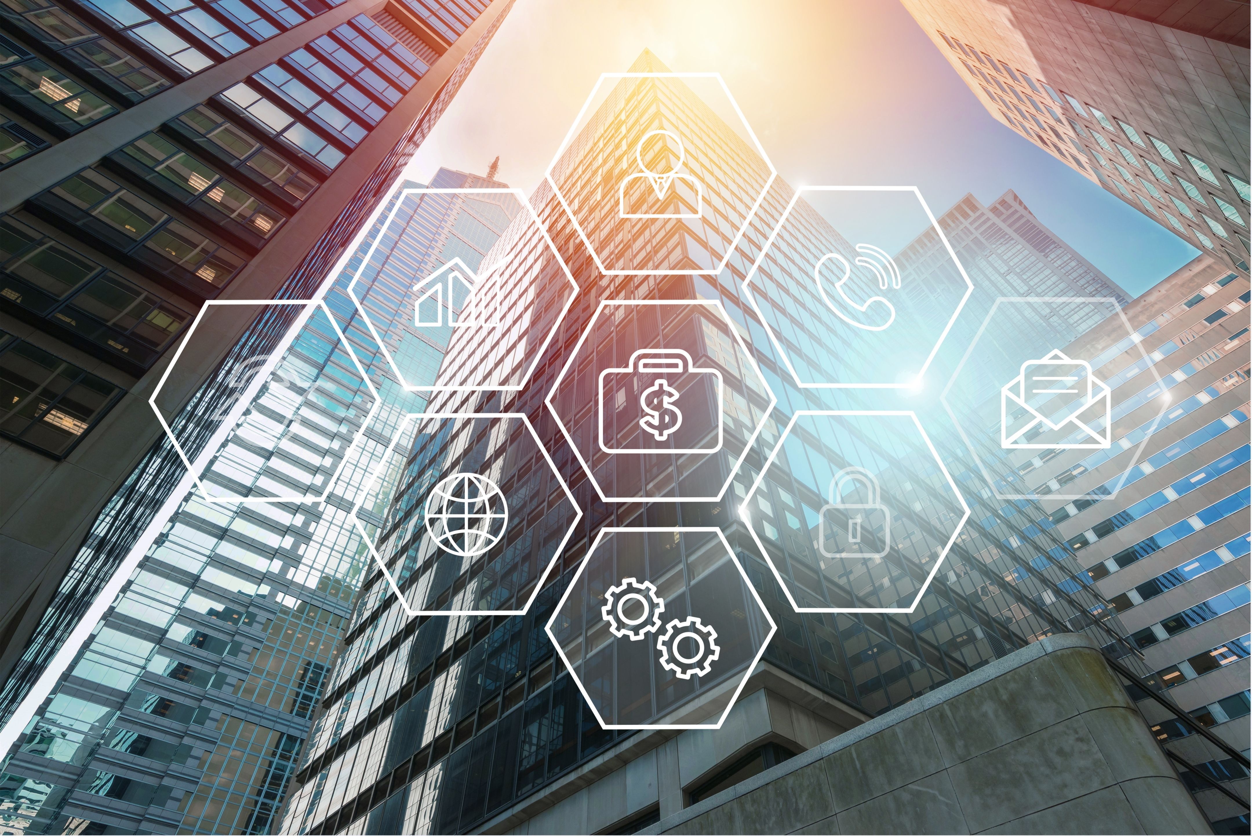 Skyscrapers with a digital overlay of business and technology icons, symbolizing connectivity and smart solutions.