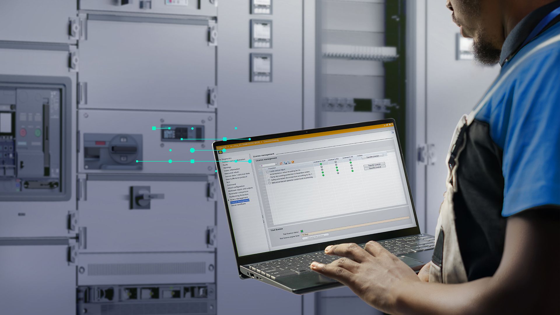 Technician using a laptop in front of electrical switchgear cabinets