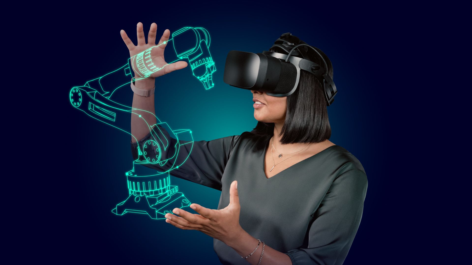 Woman in VR headset interacting with a glowing green robotic arm hologram, demonstrating virtual reality in engineering.