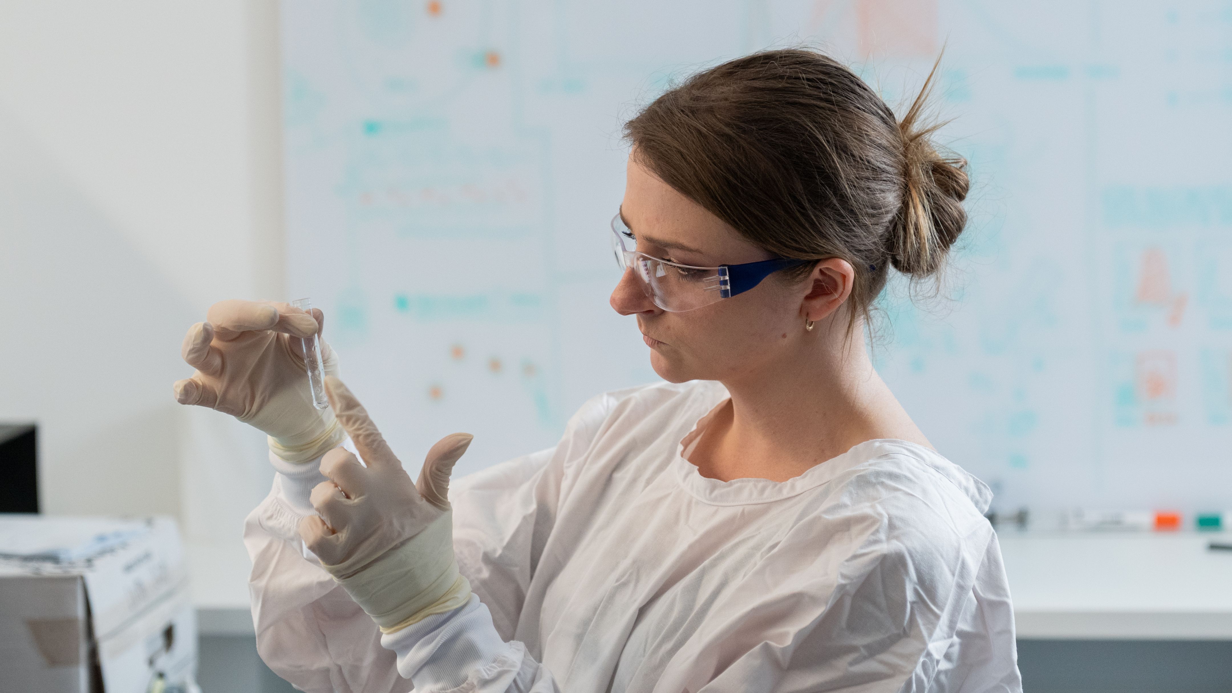 A young woman holding a test tube