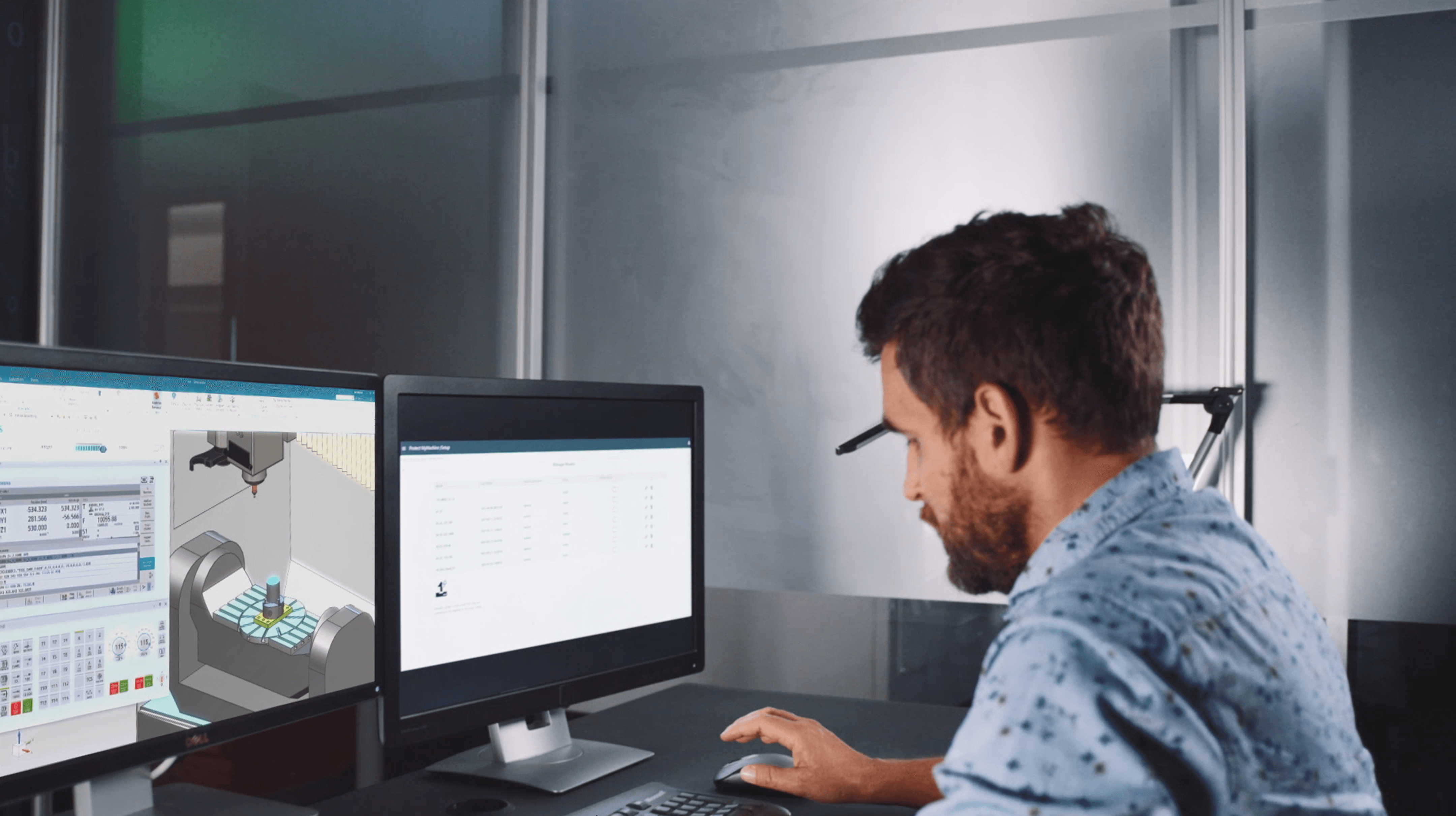  engineer working at a dual-monitor workstation.