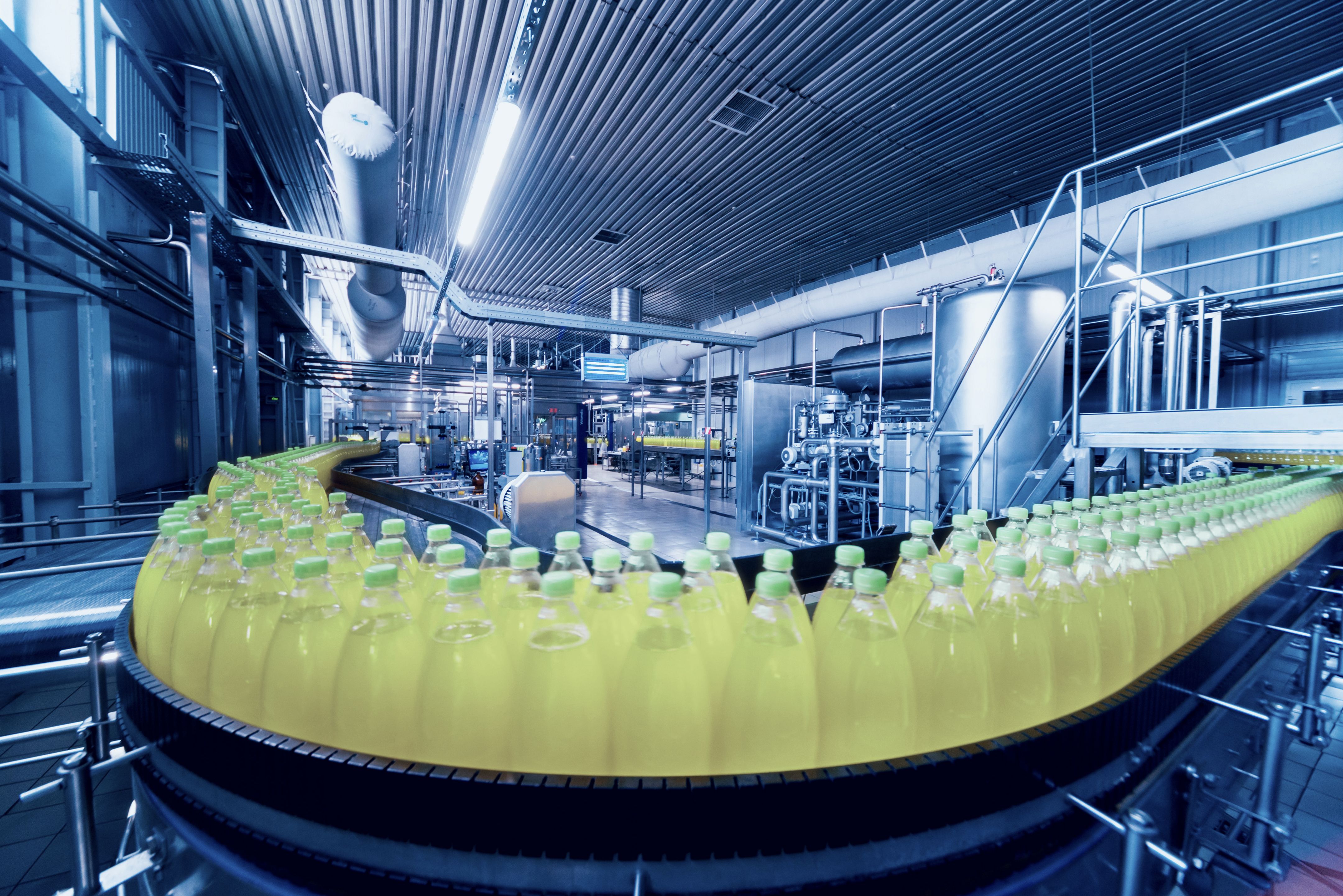 Beverage factory interior. Conveyor with bottles for juice or water.