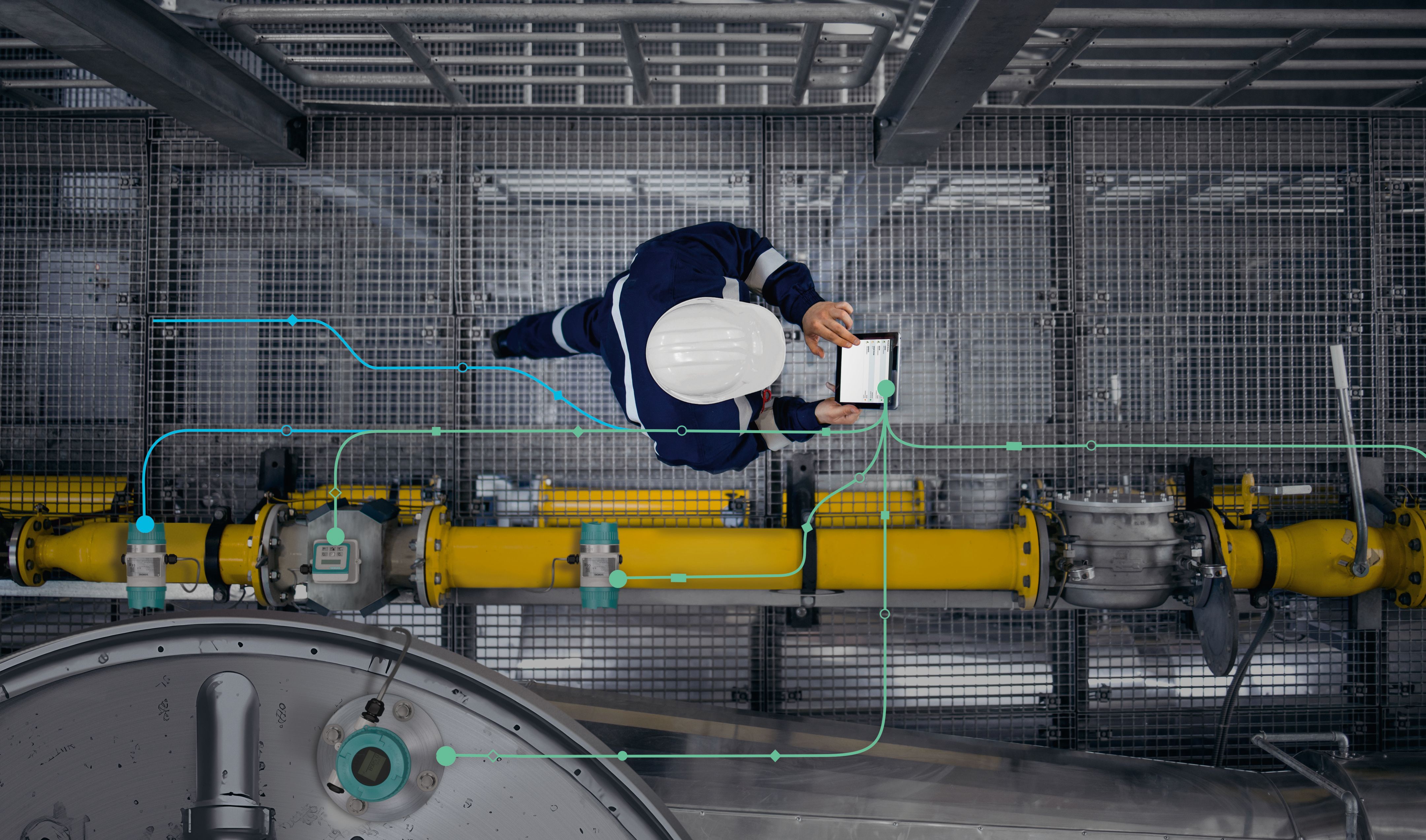 Industrial service technician inspecting production equipment with a mobile device during maintenance and diagnostics of an automated industrial system.