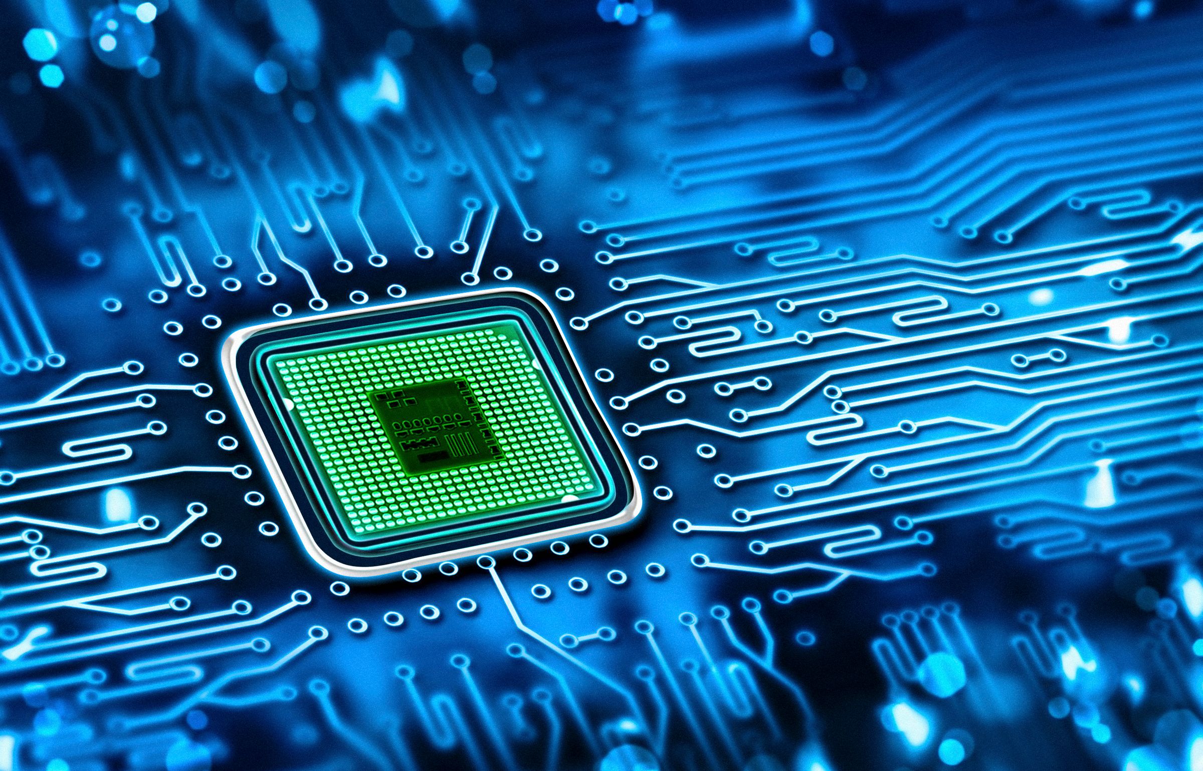 Close-up of a green microchip on a blue circuit board with interconnected electronic pathways.