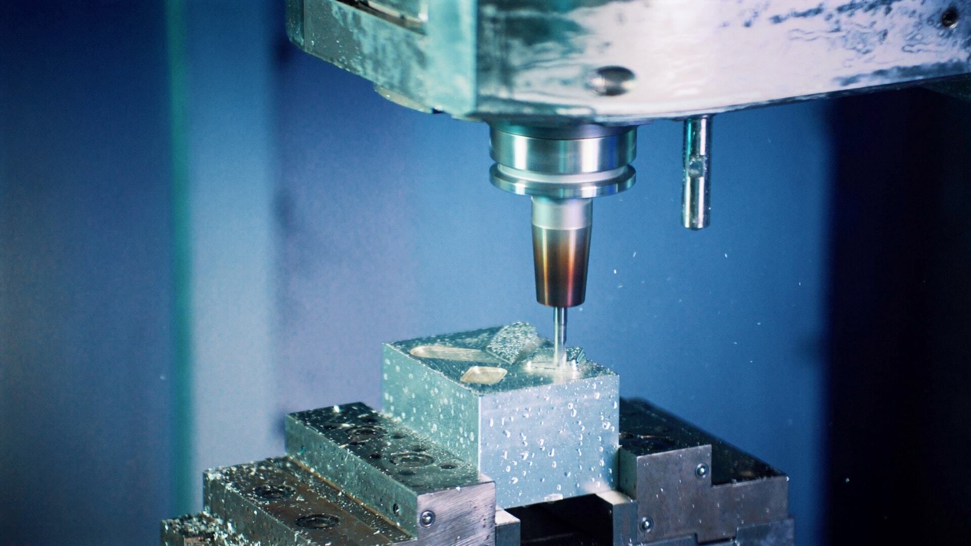 CNC milling machine cutting a metal workpiece.