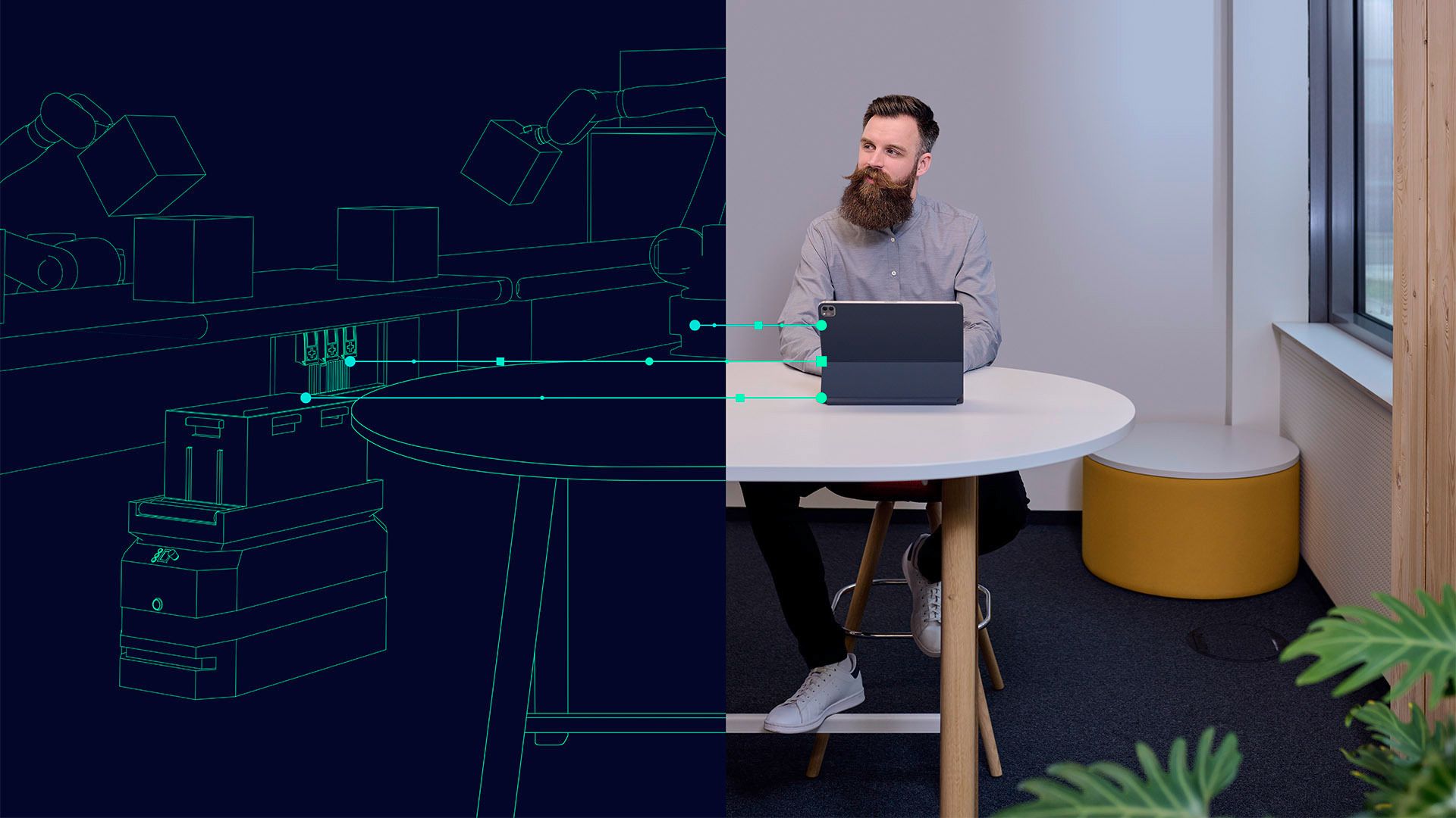 A man uses a tablet connected by lines to a digital factory with robotic arms and conveyor belts.