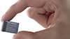 A hand holds a KEY-PLUG for Ethernet switches like the SCALANCE X-300 Gigabit switches