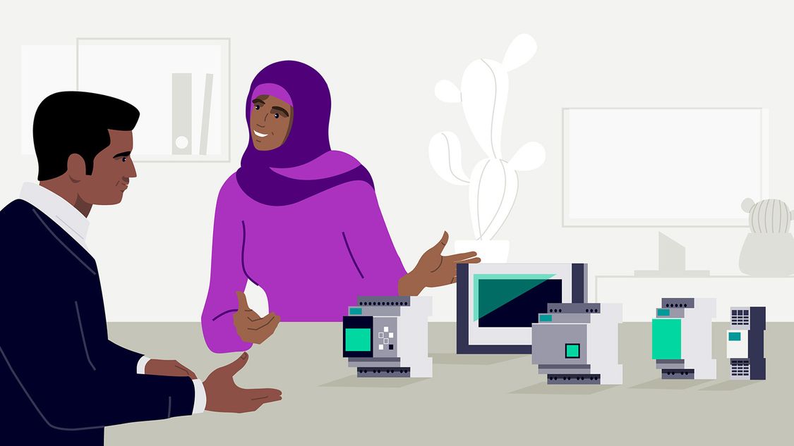 Man and woman in hijab discussing and working on a project