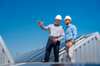 Two colleagues discussing on top of a roof Two colleagues discussing on top of a roof