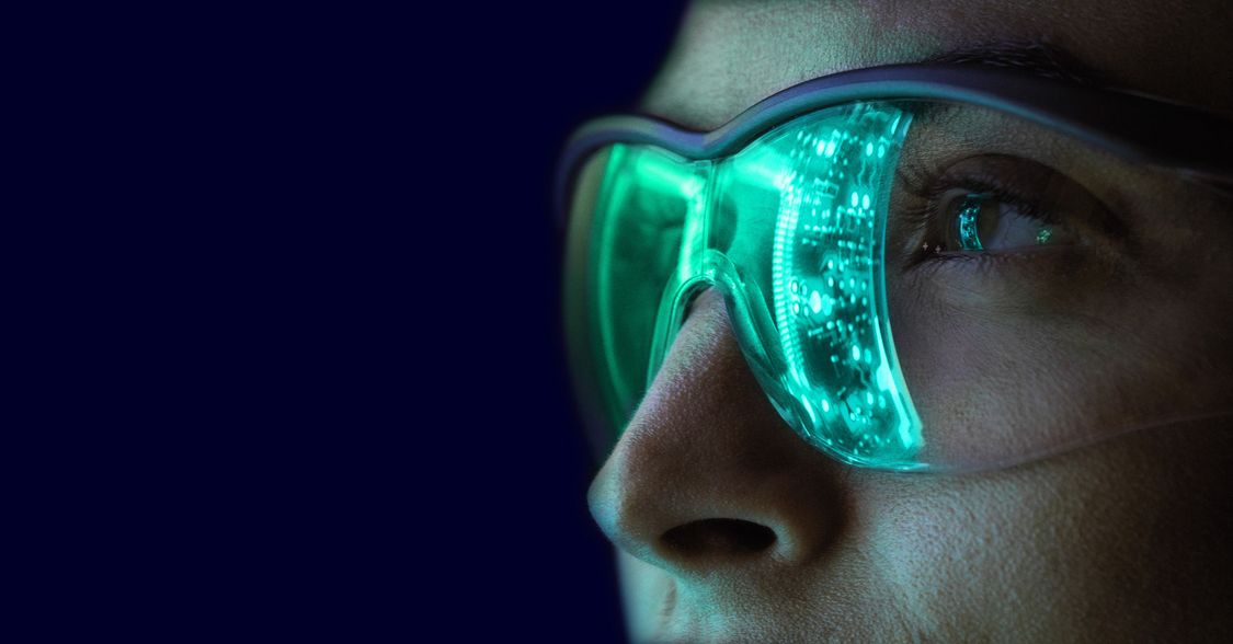 Woman with digital glasses on in the dark
