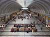 Bustling railway station concourse with arched ceiling and shops