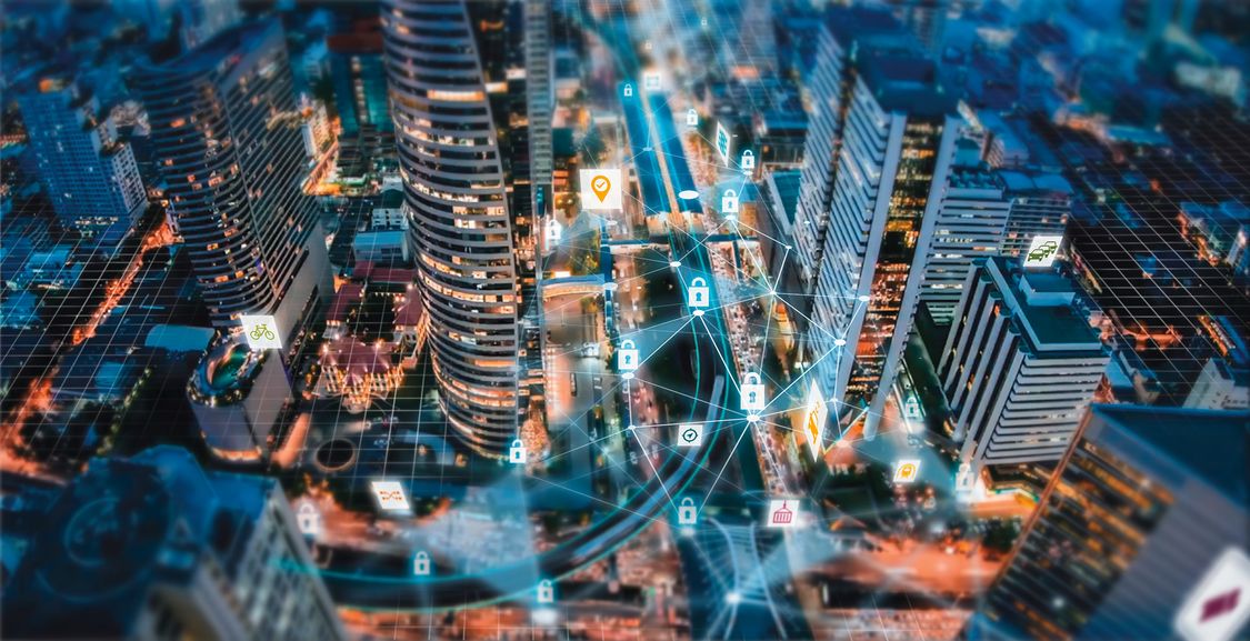 An aerial perspective of a city is overlaid with interlinked digital mobility and cybersecurity icons. 