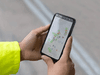 Hands holding phone with map application Hands holding phone with map application