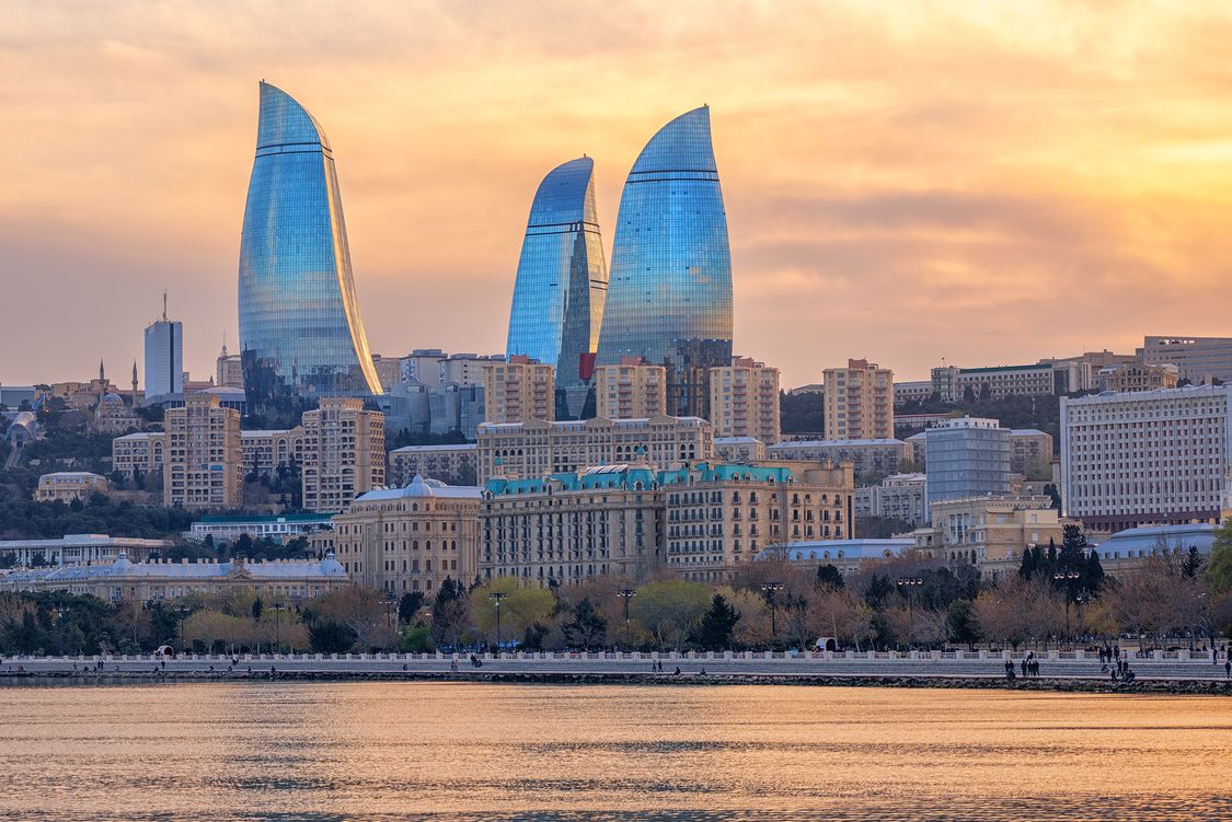 Baku, Azerbaijan, with Flower Tower skyscrapers dominating the city on dramatical sunset