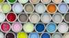 A bird’s eye view of open paint pots showing the wide range of colors available.