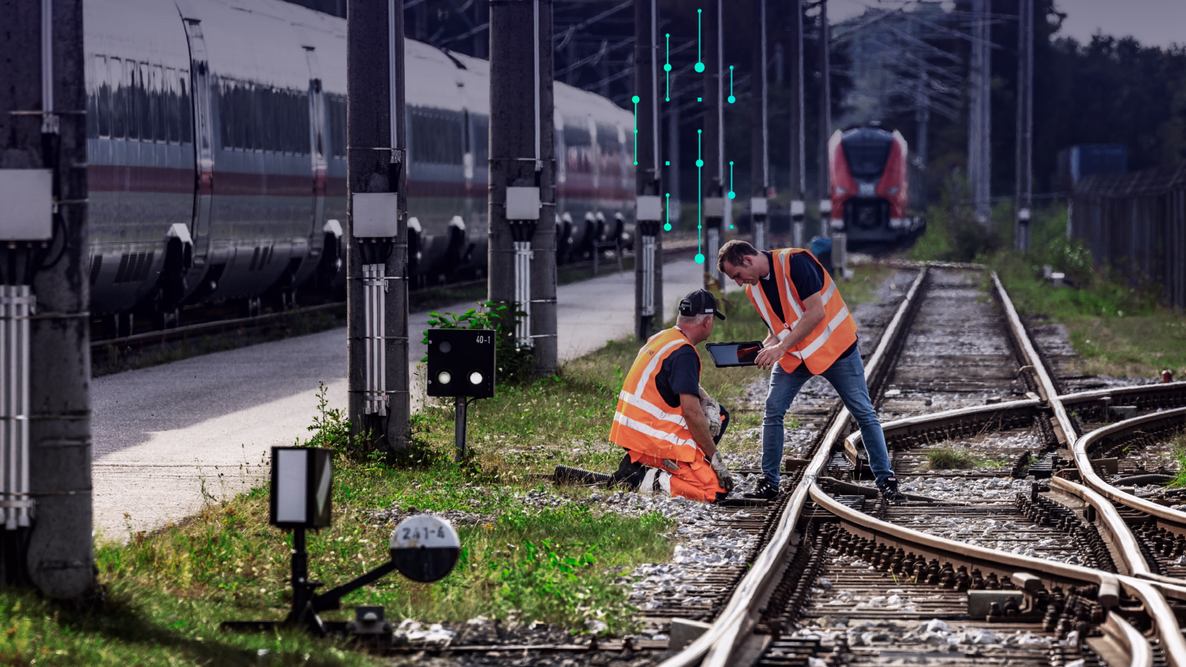 Two railway workers in safety vests inspect tracks with a tablet, while digital data points rise above them, and trains are visible in the background. siemens-mobility-railxplore-fusion-keyvisual