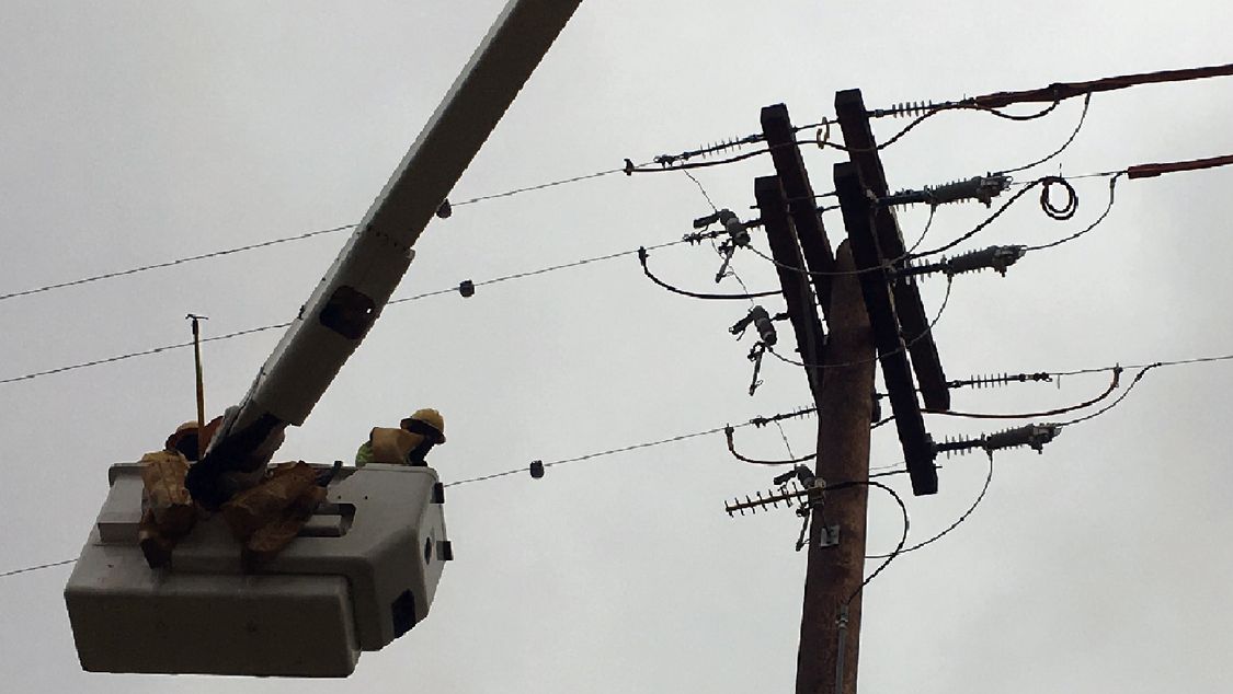 Electrical technician working on power lines