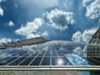 Modern skyscraper with solar panels reflecting cloudy sky Modern skyscraper with solar panels reflecting cloudy sky