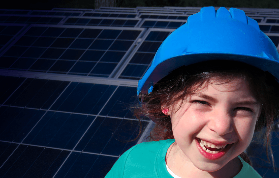 Little girl smiling in hard hat