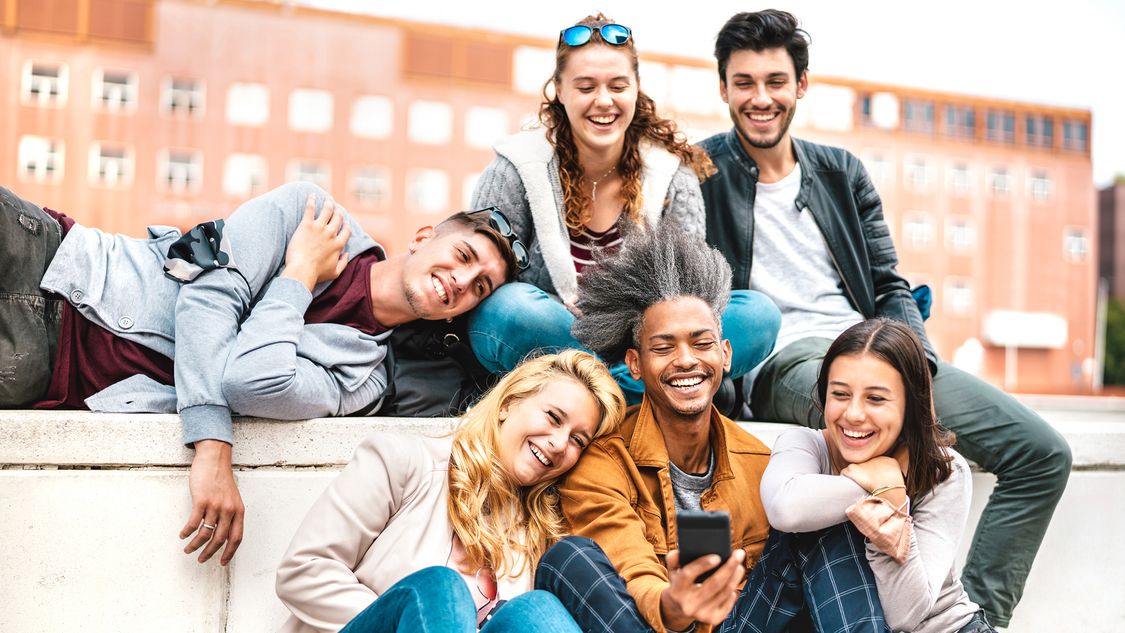 A group of students sitting on a wall