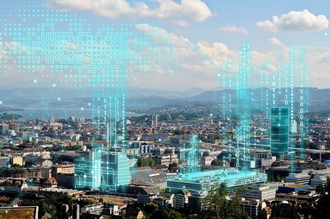Na zdjęciu przedstawione jest nowoczesne miasto, wyposażone w zintegrowane rozwiązania z zakresu smart buildings
