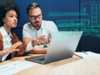 Colleagues discuss project with holographic building design