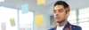 Man in blue blazer standing confidently in office with sticky notes global-business-asia-pacific-hub