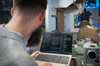 An engineer uses automated engineering tools on his laptop to develop an industrial machine. An engineer uses automated engineering tools on his laptop to develop an industrial machine.