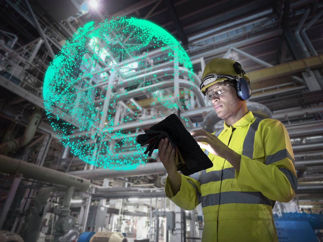 Man in safety clothing looking at tablet