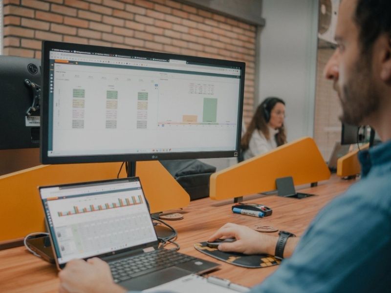 People working with data on computers in office