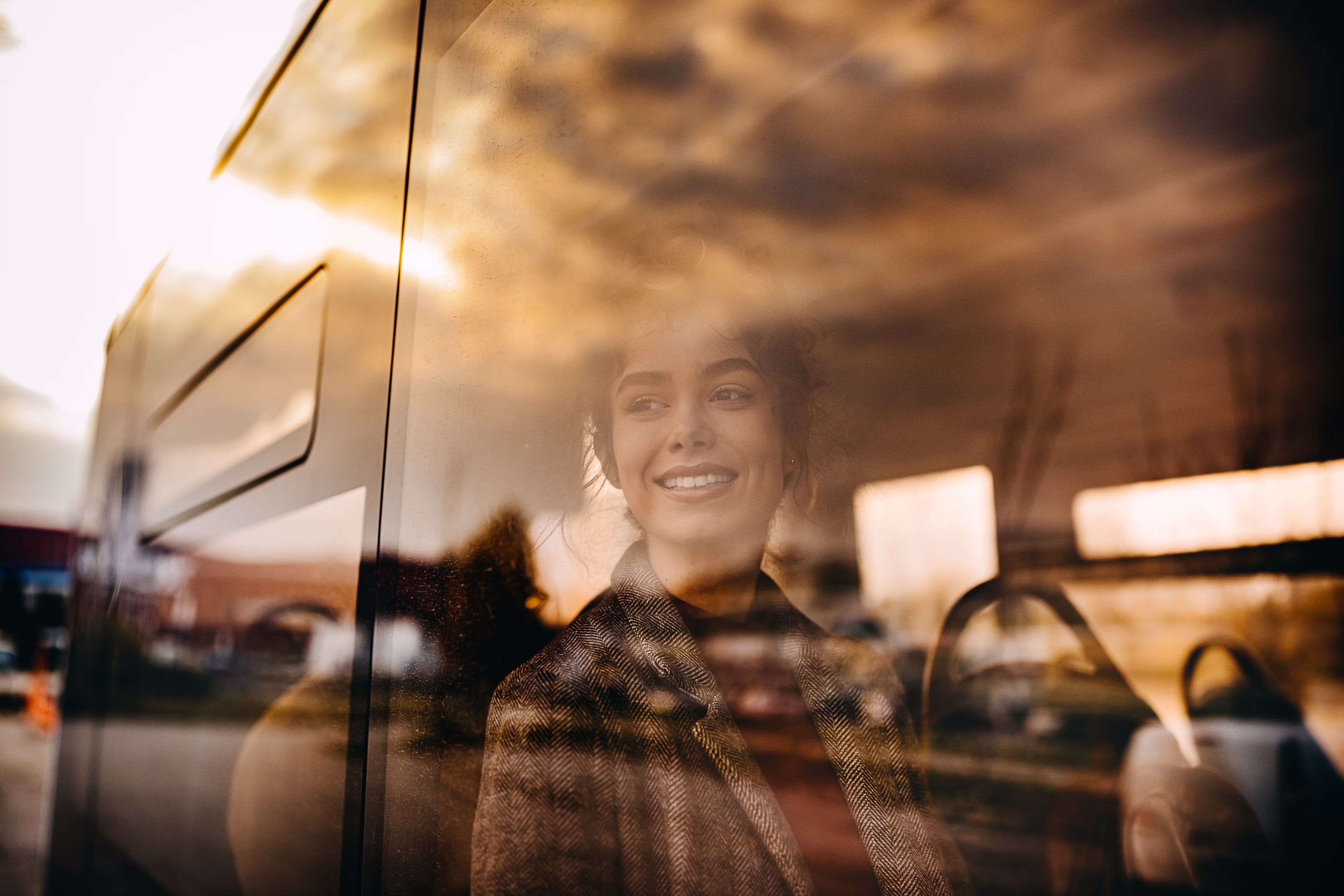 woman looking out of the window of a mini bus woman looking out of the window of a mini bus
