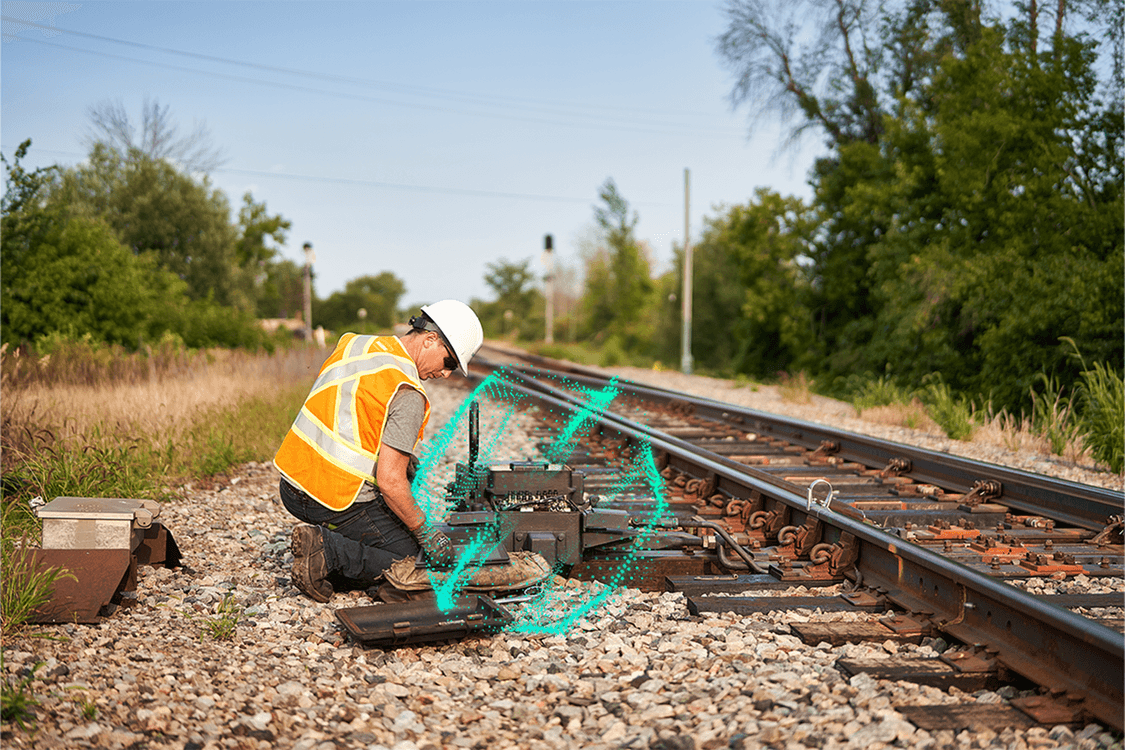 Rail worker working on tracks with digital layer
