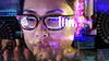 digitally enhanced woman wearing glasses and looking at analytics