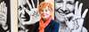Woman with vibrant orange hair by portraits with hand messages