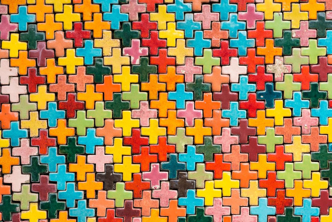 Mulit-colored puzzle pieces that represent diverstiy and intersectionality