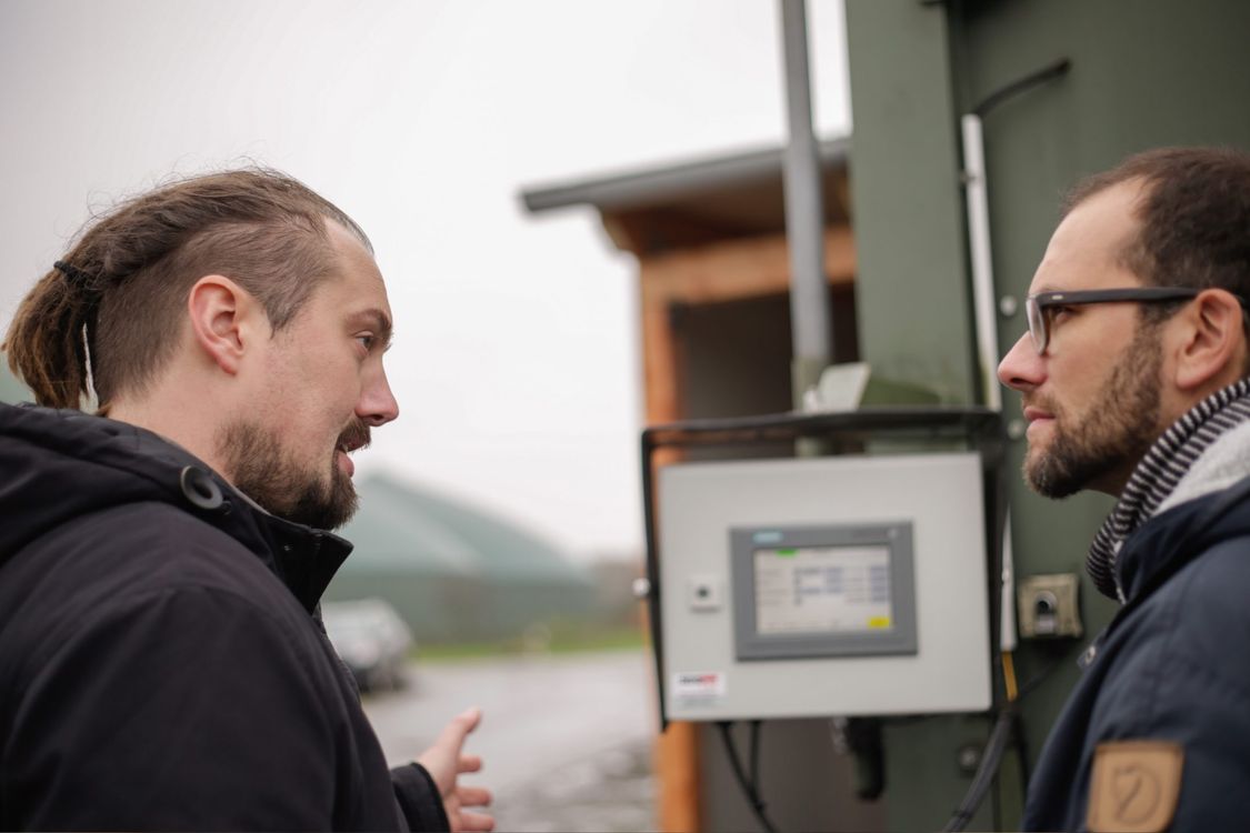  Daniel Schwier, Geschäftsführer SDS tec , unterhält sich mit weiterem Mann vor Outdoor Panel