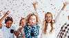 Confetti falling with kids throwing their hands up