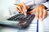 Lady with calculator checking hire purchase figures