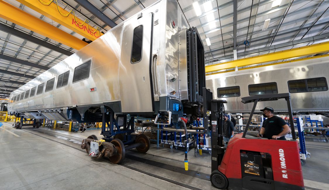 Machine pulling a train car shell