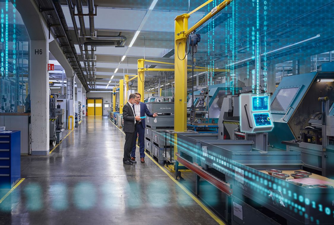 businessmen in digitalized manufacturing plant