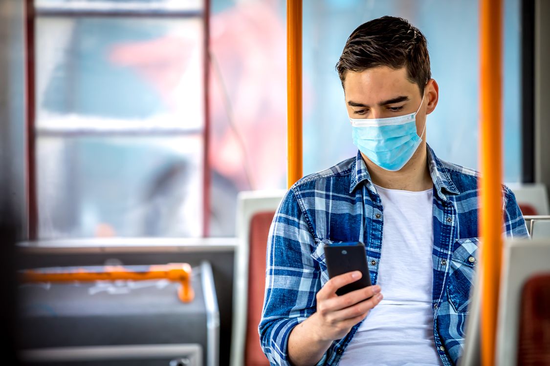 man sitting in bus with mask
