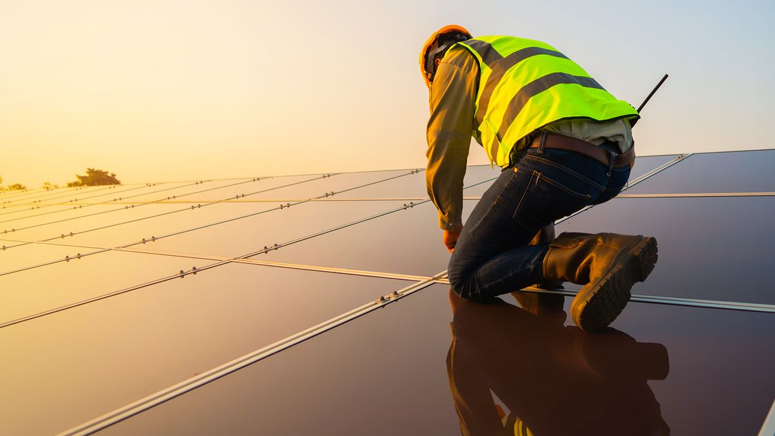 Worker on solar panels