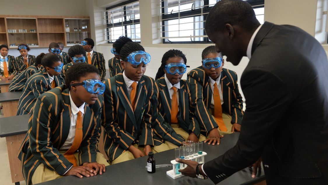 Students watching an experiment in the Mandela School