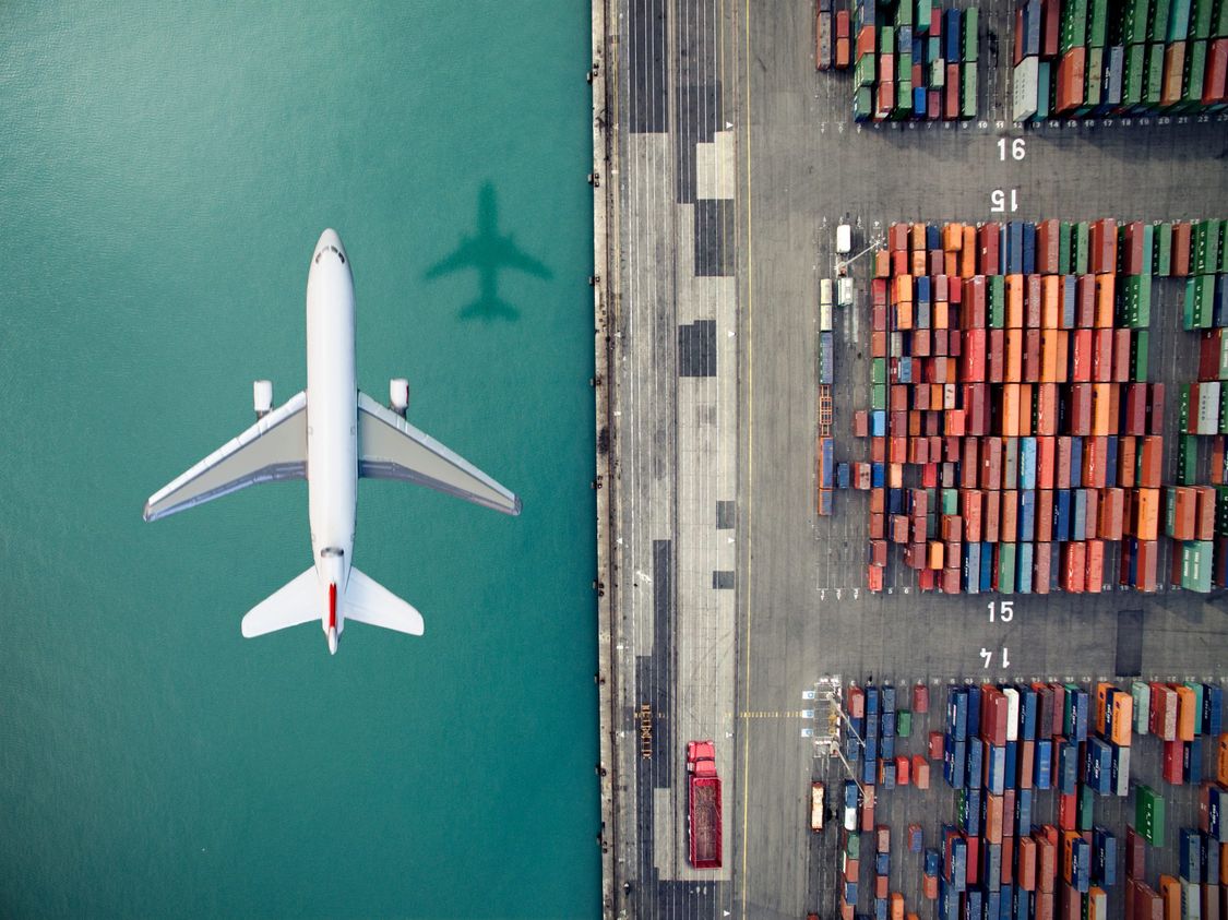 Airplane flying over container