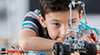 a young boy student building an electric car a young boy student building an electric car