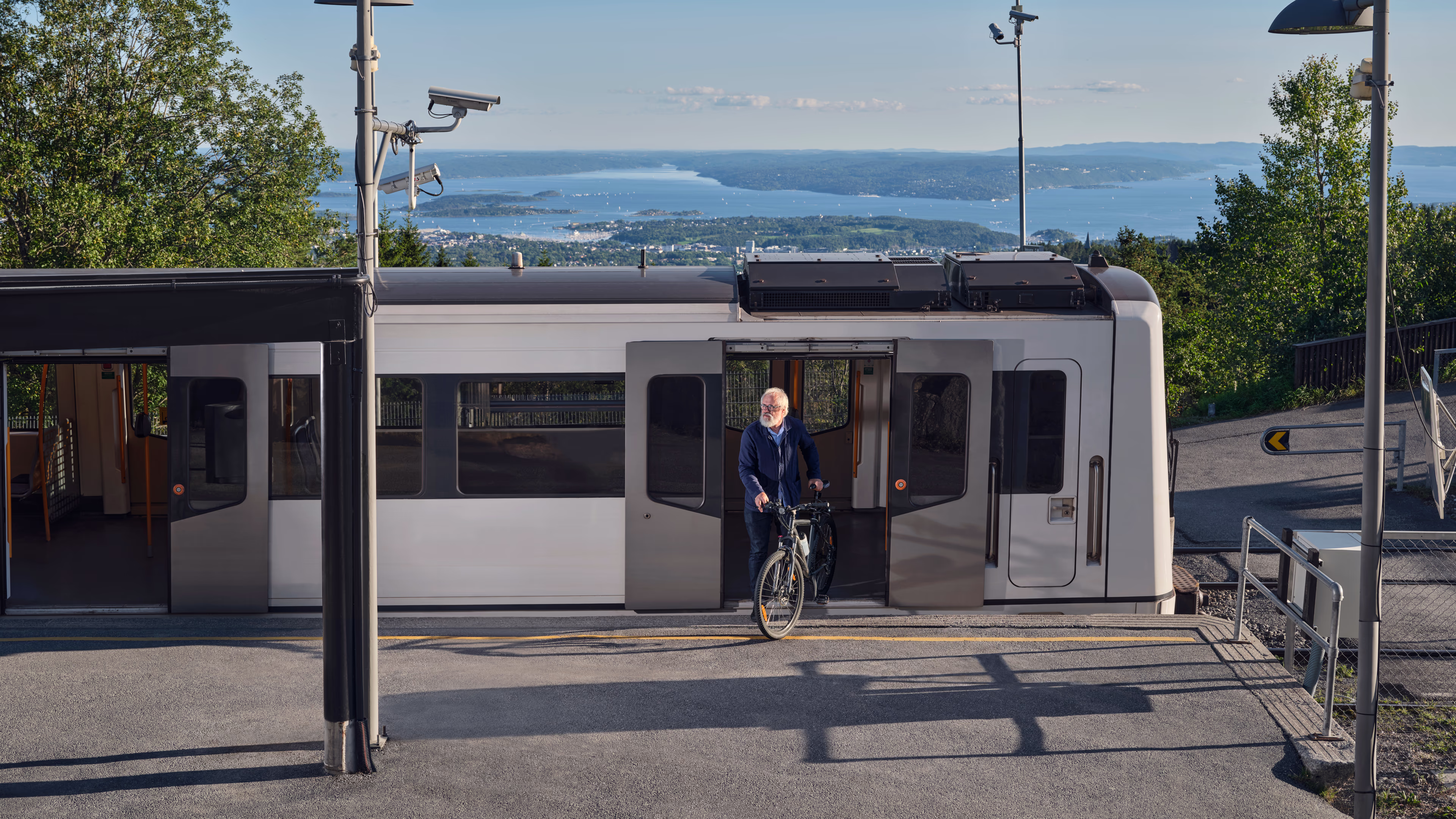 Train car with cyclist boarding, overlooking scenic coastal view customer-experience