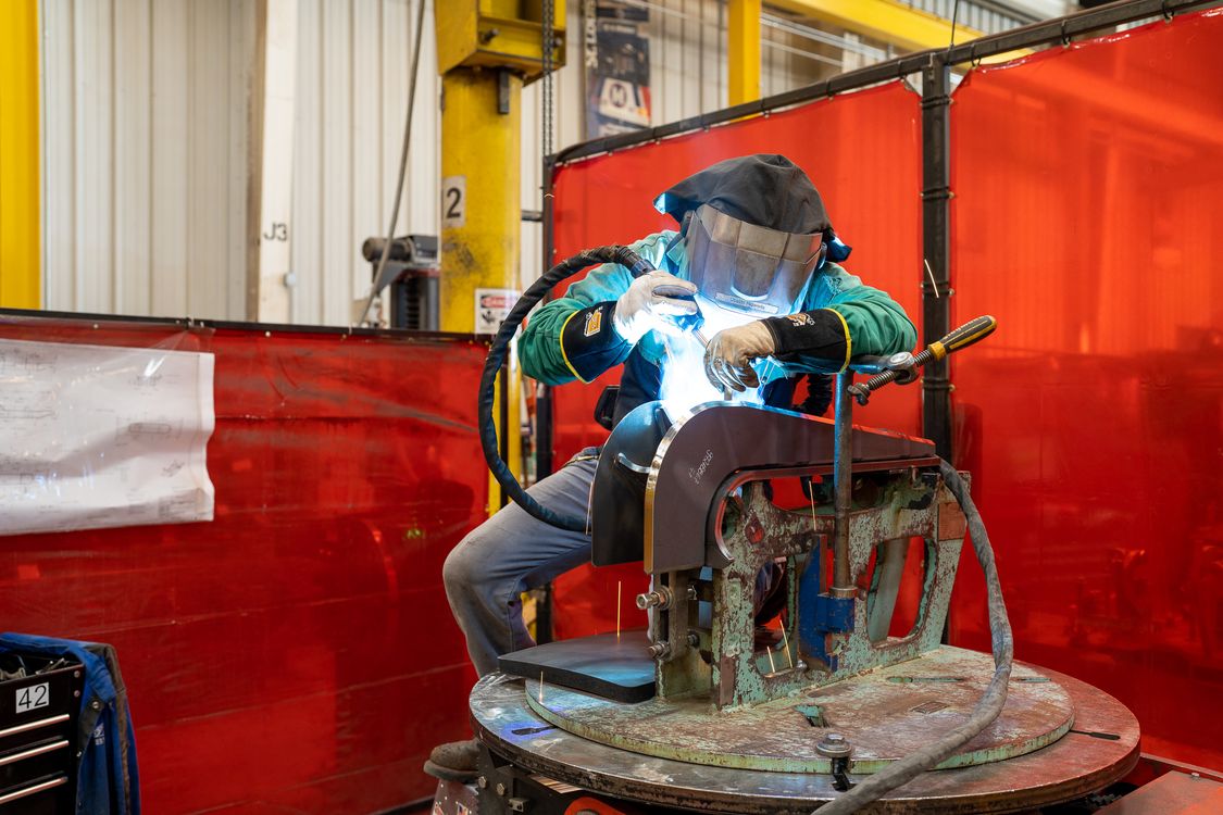 Welder working at manufacturing facility 