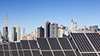 Roof top solar installation with Midtown Manhattan view as background, Chryler Building and Empire State Building.